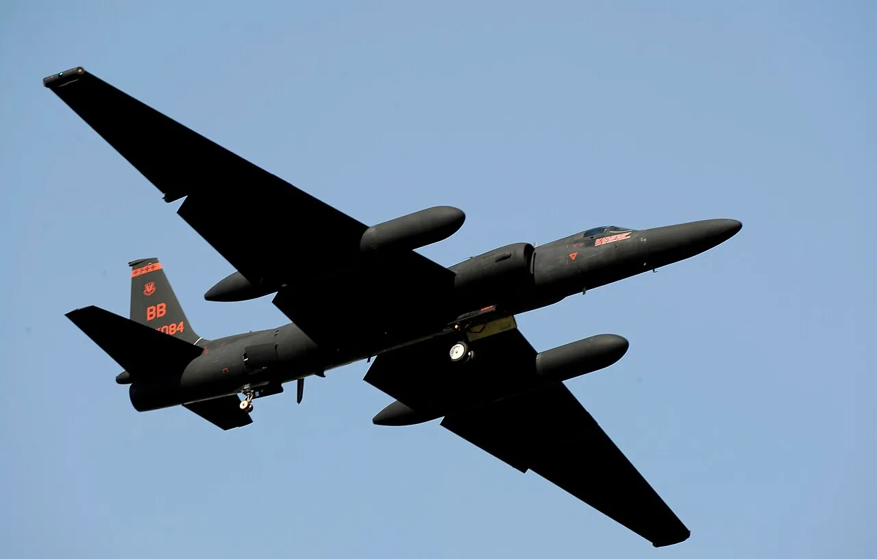 A Lockheed U-2 spy plane climbing steeply away from the runway after takeoff, its long glider-like wings and single tall tail visible against the sky.