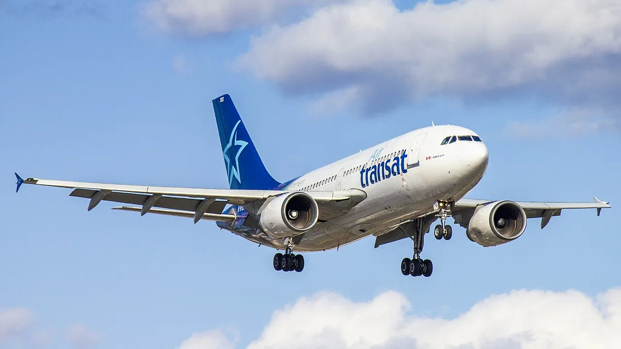 An Air Transat Airbus A310-308 on approach to land, landing gear down.