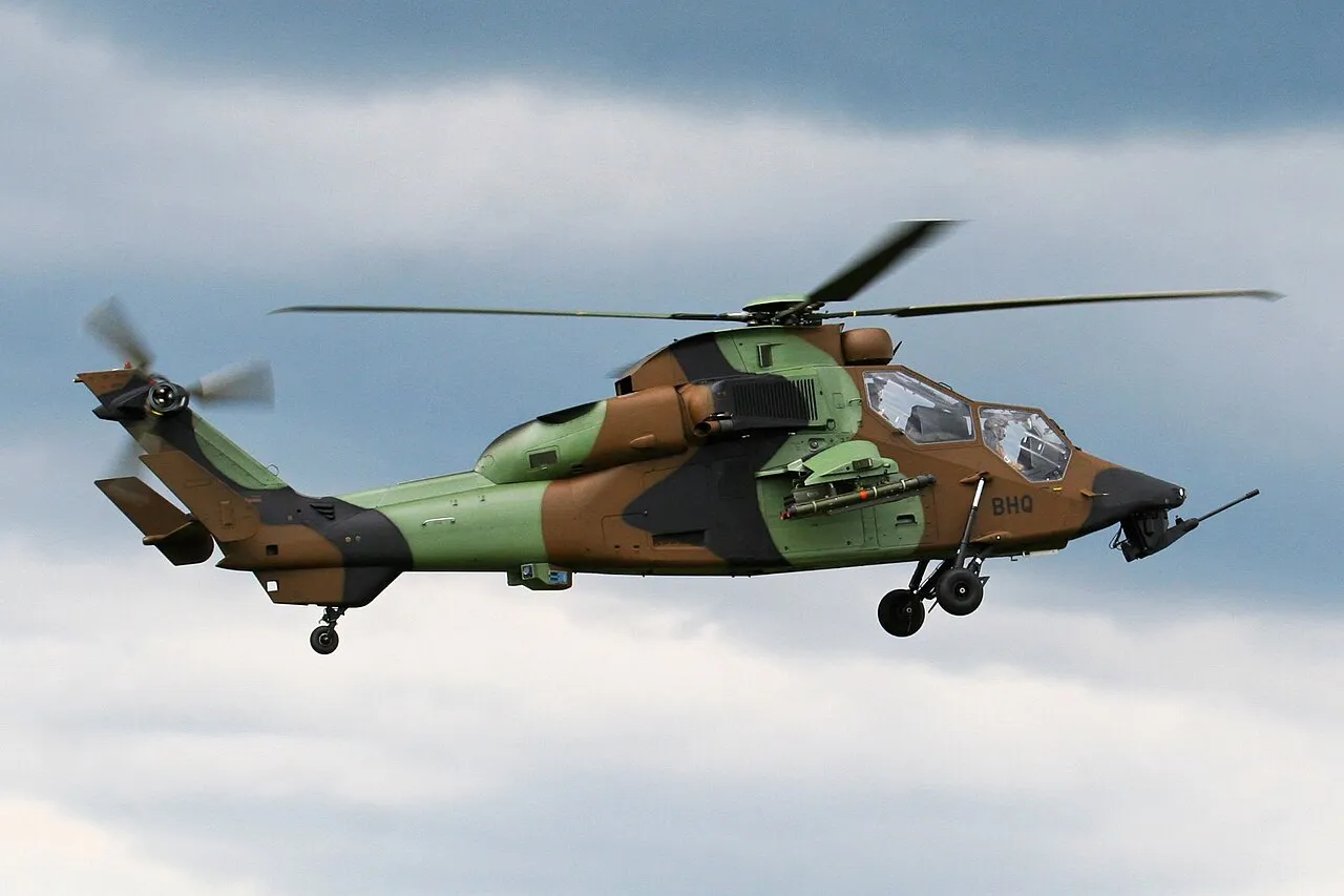 A Eurocopter Tiger attack helicopter on display, its mast-mounted sight above the rotor hub and a cannon under the nose.