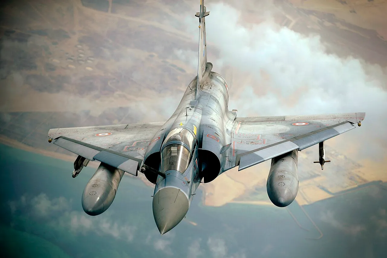 A French Air Force Mirage 2000 fighter pulling away after aerial refuelling from a KC-10A tanker during a multinational exercise.
