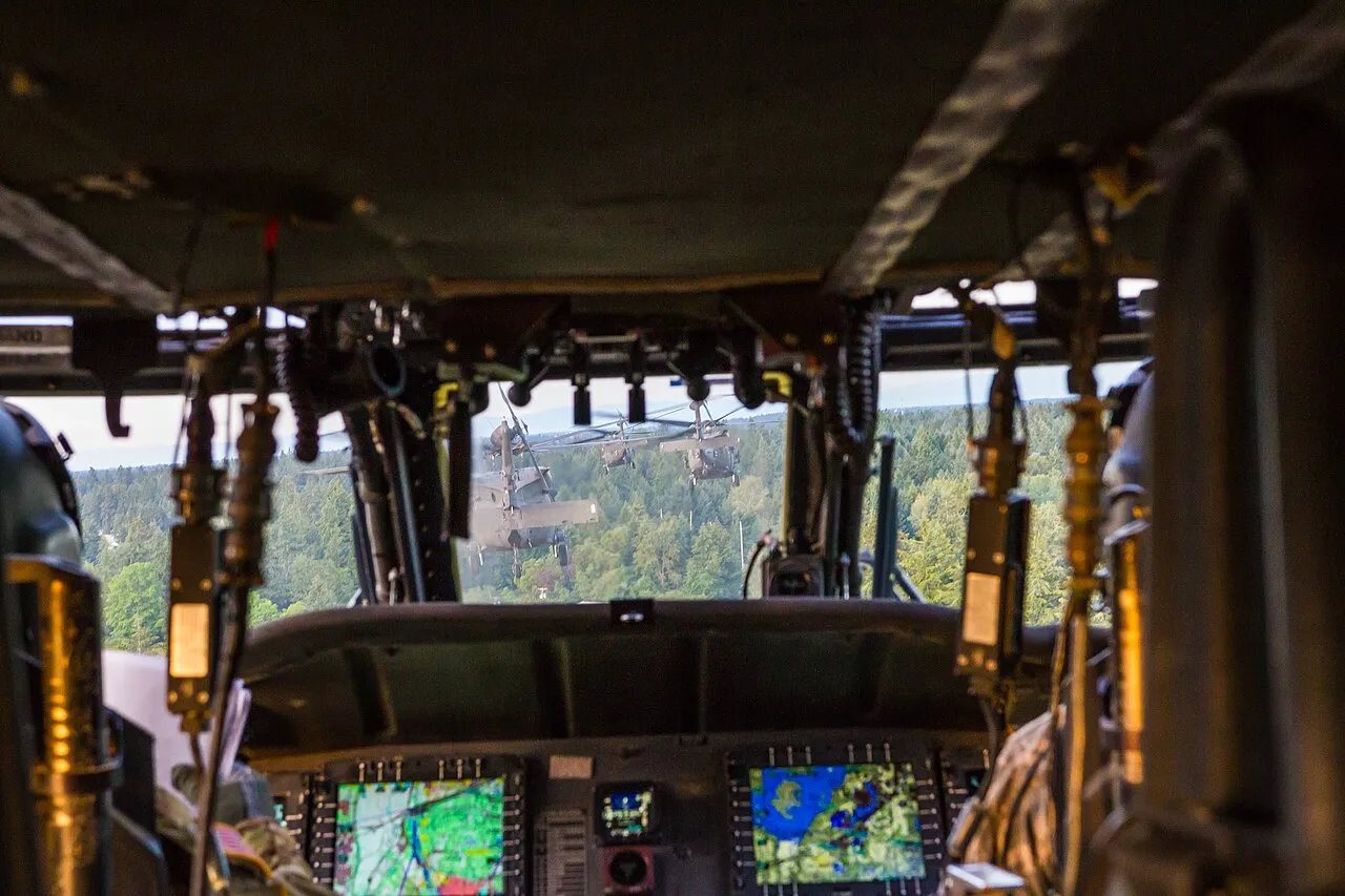 Two U.S. Army UH-60 Black Hawk helicopters flying in formation near Joint Base Lewis-McChord, Washington.