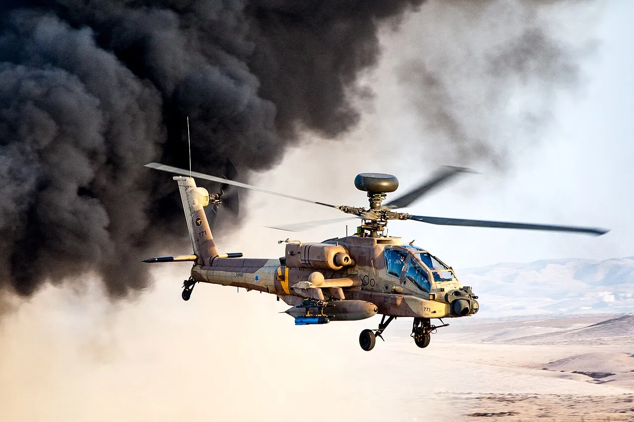 An Israeli Air Force AH-64D Apache Longbow attack helicopter seen from the side in flight, its distinctive tandem cockpit and stub-wing pylons visible.