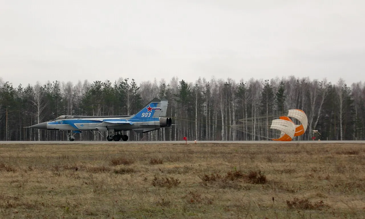 A Russian MiG-31E interceptor landing at Sormovo Airfield with its drogue brake parachute deployed.