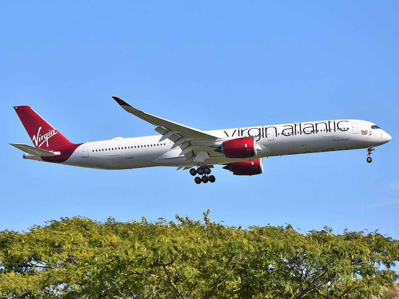 A Virgin Atlantic Airbus A350-1000 on final approach, its twin Rolls-Royce engines and raked wingtips visible.