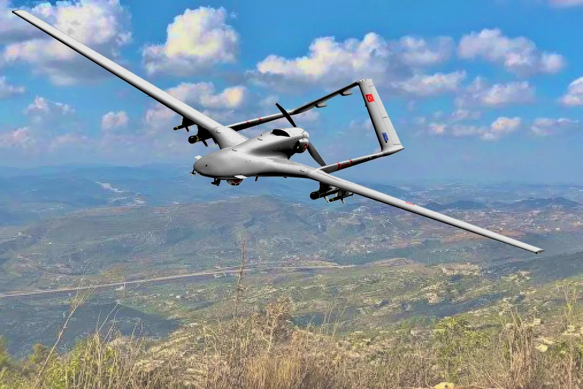 A Turkish-made Bayraktar TB2 unmanned combat aerial vehicle in flight, showing its twin-boom tail and underslung sensor pod.