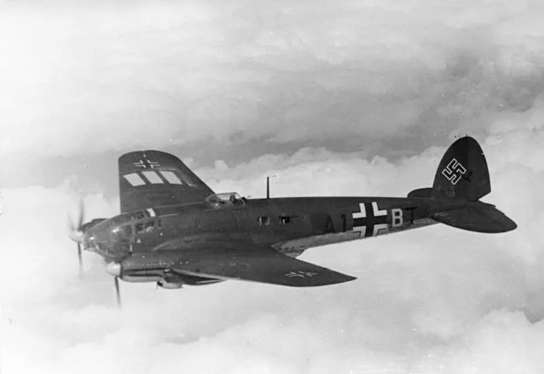 A German Heinkel He 111 H-2 twin-engine bomber in flight over Belgium or France in 1940, carrying the tactical code A1+BT.