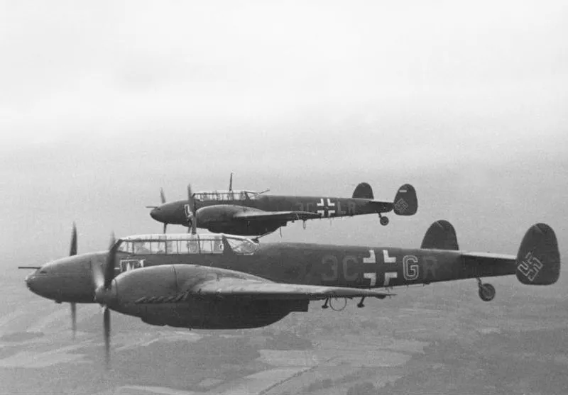 Two Messerschmitt Bf 110 (Me 110) twin-engine heavy fighters of Nachtjagdgeschwader 4 in flight over western France, 1942.