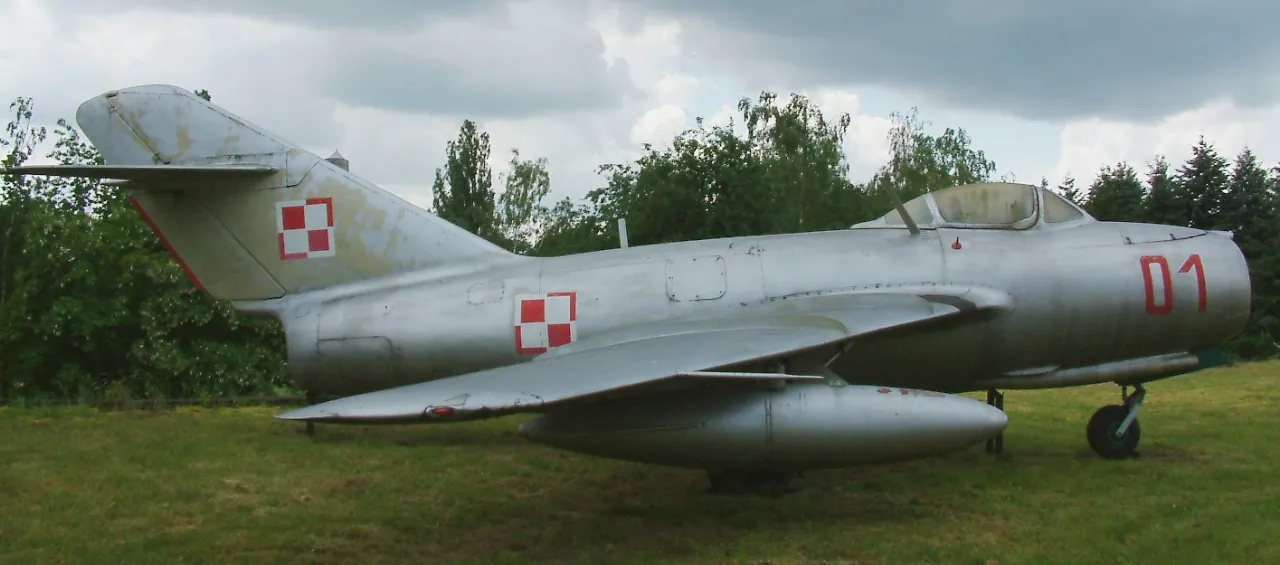A preserved Mikoyan-Gurevich MiG-15 fighter jet on display at a museum in Poznan, Poland