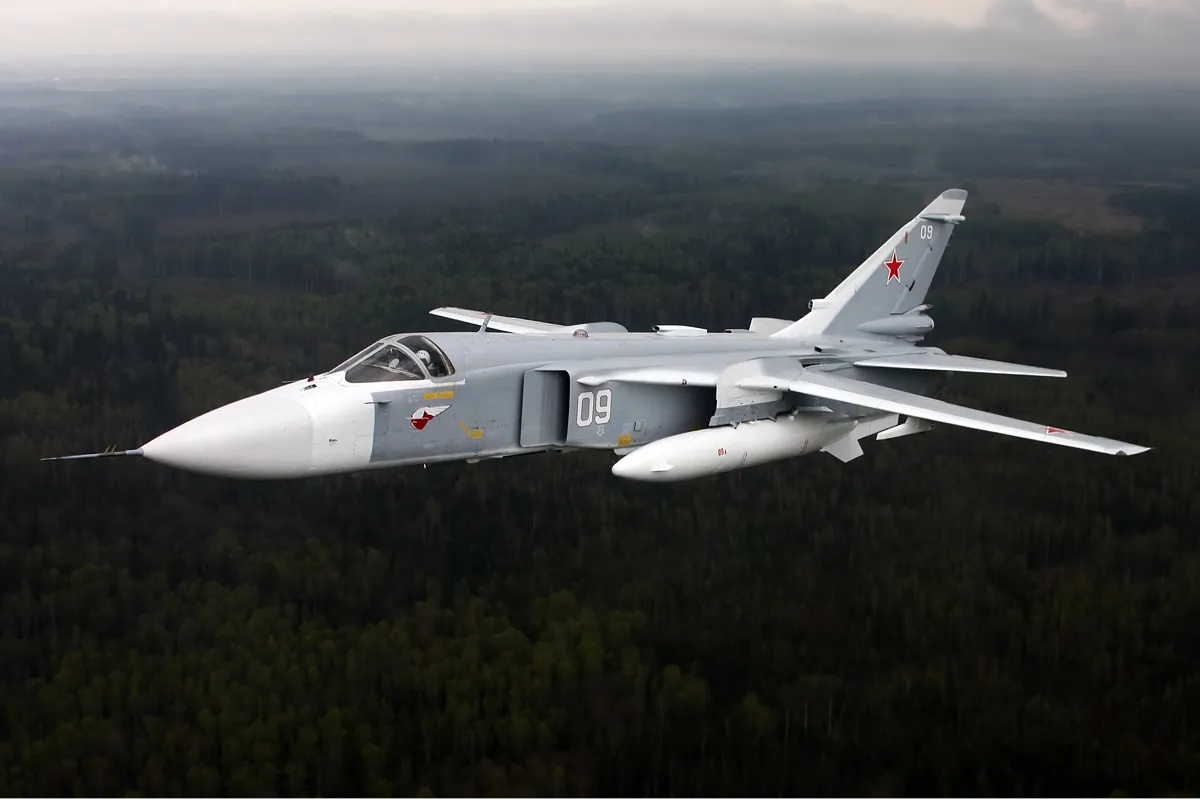 A Russian Air Force Sukhoi Su-24M swing-wing strike aircraft seen from the side in flight.